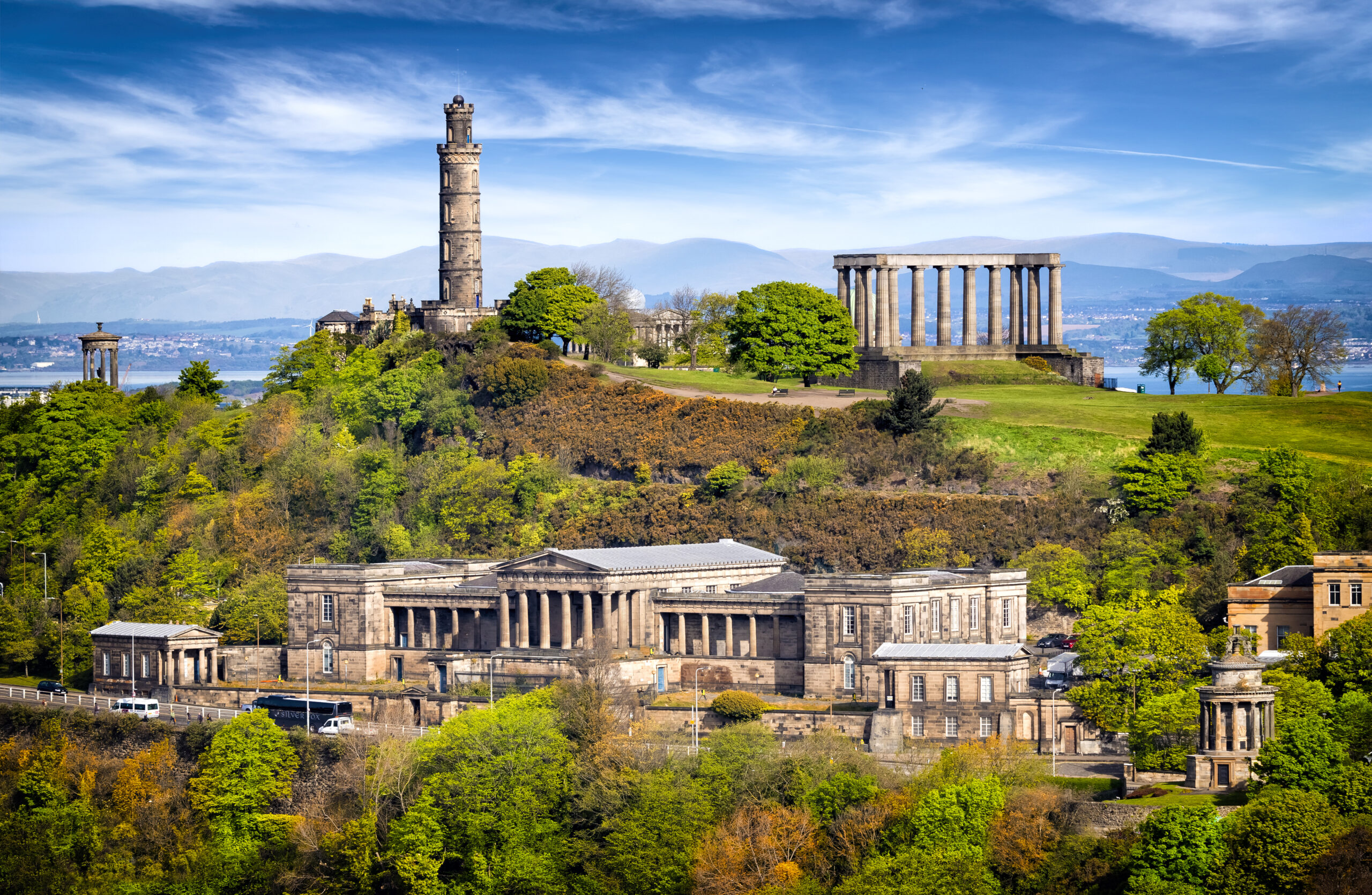 Nelson Monument and National Monument on Edinburgh’s Calton Hill above the Old Royal High School.