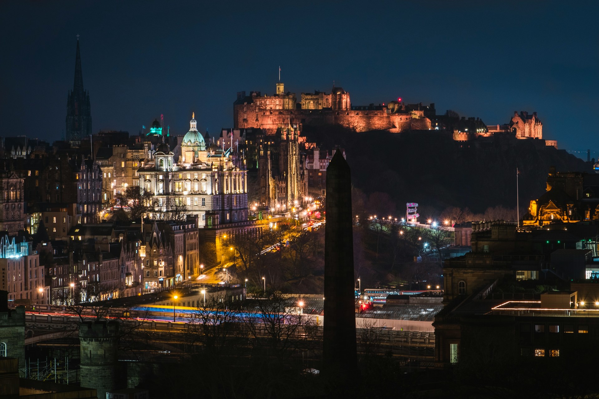 Edinburgh Castle and Old Town buildings illuminated against the night sky.